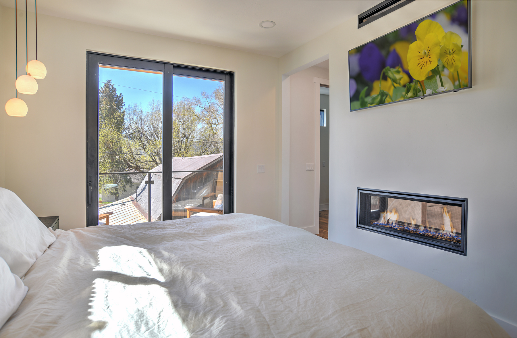 Unwind in this spacious king bedroom with an electric fireplace, Smart TV, and ensuite bathroom. 