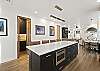 This beautifully furnished retreat features high-end stainless-steel appliances, large granite countertops, kitchen island and a walk-in pantry. 