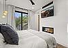 Our primary bedroom features a king bed, pass-through gas fireplace, Smart TV, private balcony, and ensuite bathroom.