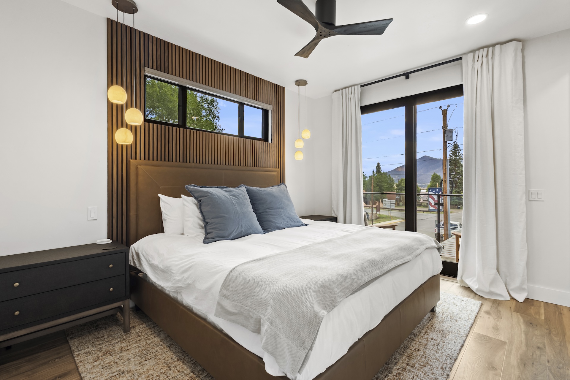 Retreat to the elegant primary bedroom, featuring a plush king bed and a private balcony where you can unwind and soak in the mountain scenery.