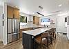 This beautifully furnished retreat features high-end stainless-steel appliances, large granite countertops, kitchen island and a walk-in pantry. 