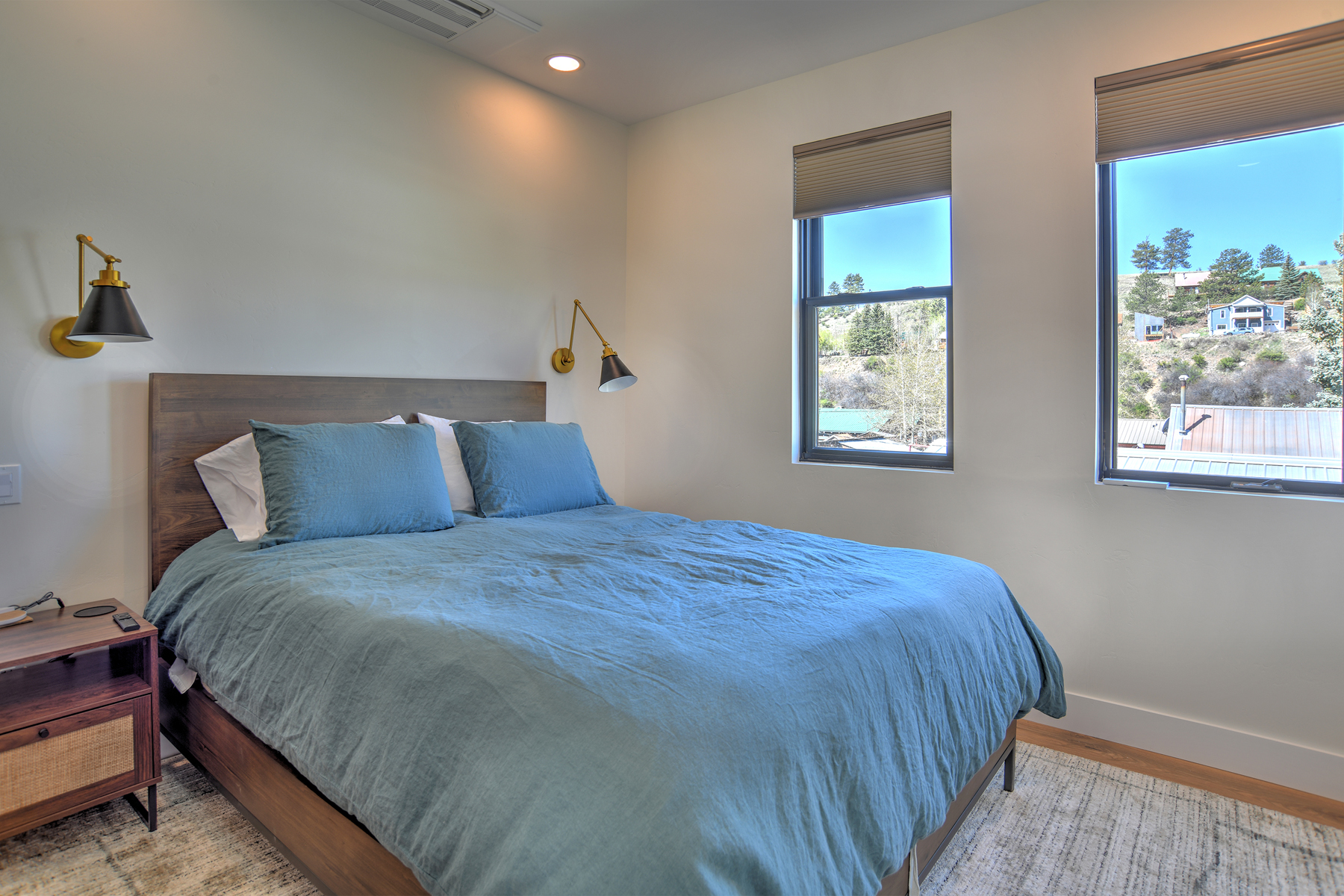 Cozy queen bedroom with natural light and a Smart TV. 