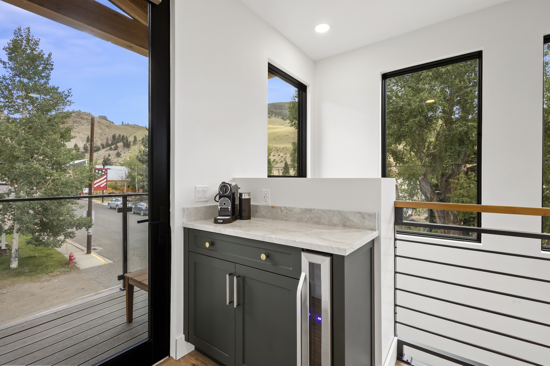 Our second level offers its own mini coffee and wine bar — perfect for starting or ending your day as you step out onto the north-facing balcony.