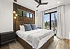Retreat to the elegant primary bedroom, featuring a plush king bed and a private balcony where you can unwind and soak in the mountain scenery.