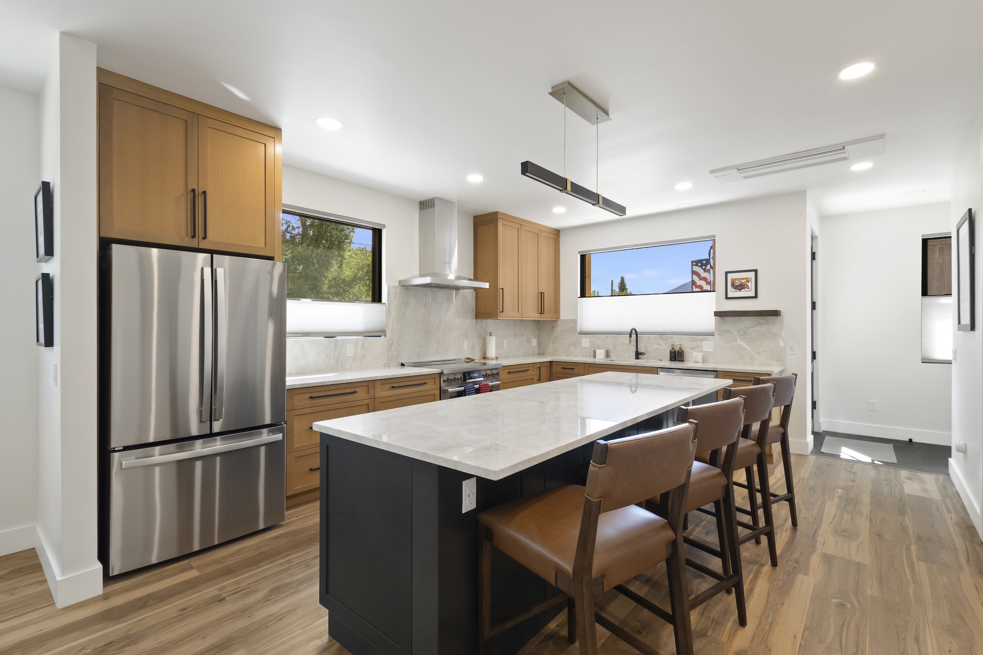 This beautifully furnished retreat features high-end stainless-steel appliances, large granite countertops, kitchen island and a walk-in pantry. 
