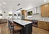 This beautifully furnished retreat features high-end stainless-steel appliances, large granite countertops, kitchen island and a walk-in pantry. 