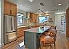 The stunning chef's kitchen has everything you need to cook up a great meal, with a large island and bar seating for 4. 