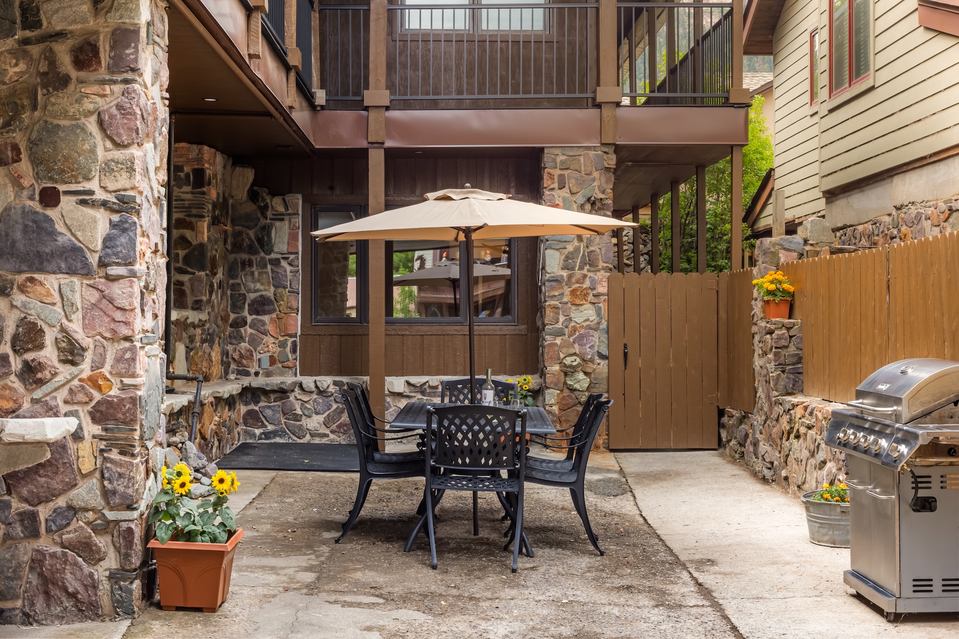 Private lower courtyard with propane grill and outdoor seating