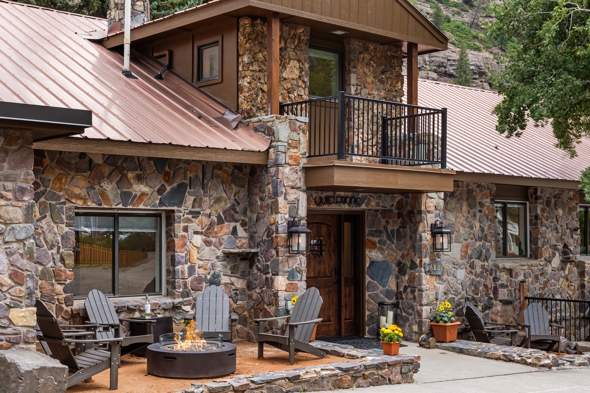 Front Outdoor Lounge Space with Adirondack Chairs and Propane Fire pit. 