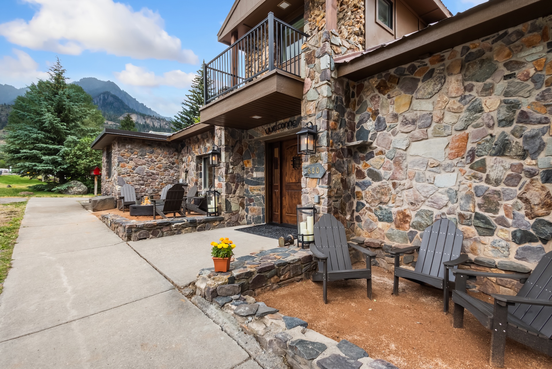 Front Outdoor Lounge Space with Adirondack Chairs and Propane Fire pit. 