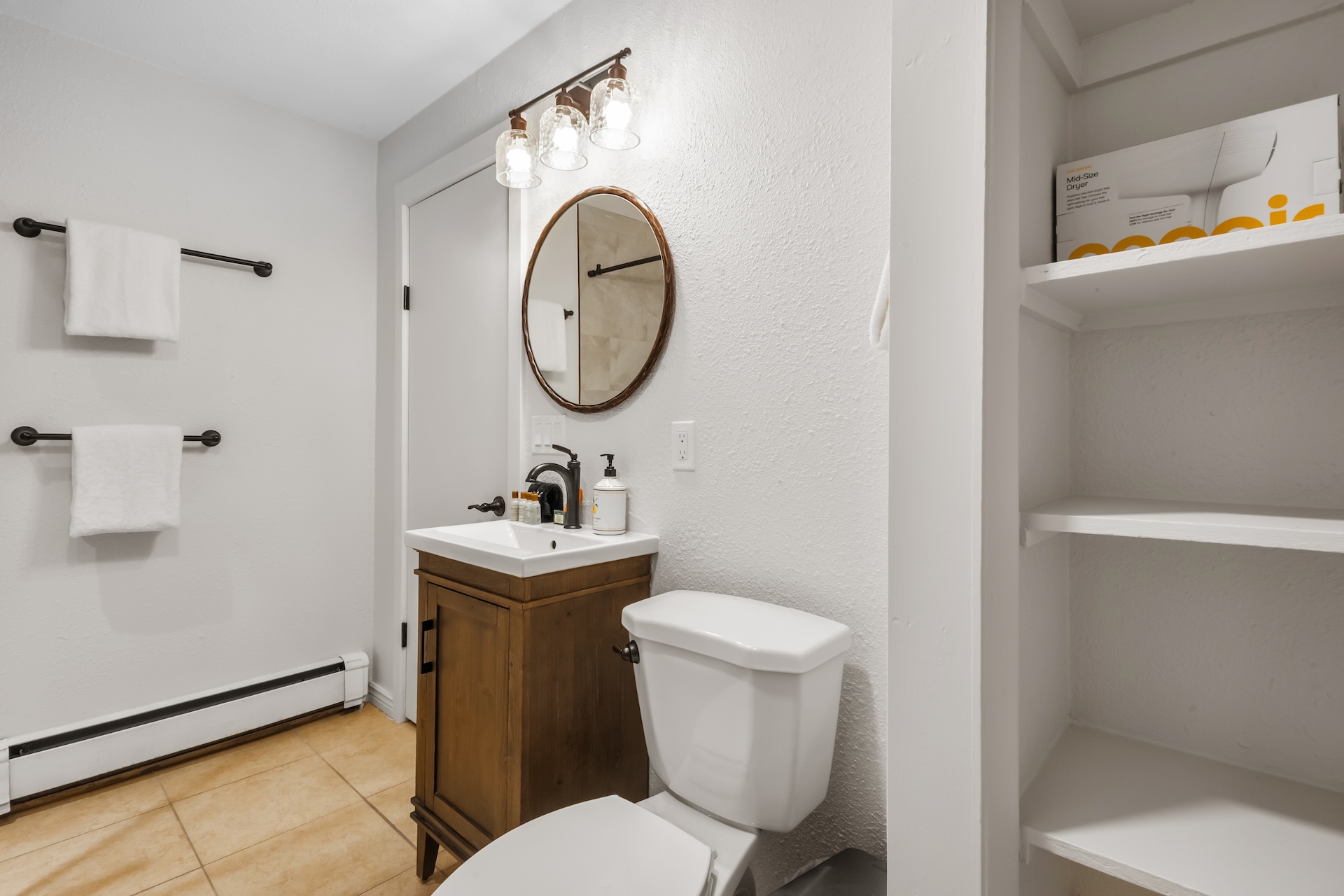 A full bathroom with a sleek walk-in shower is located across the hall from the third King bedroom. 