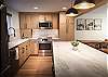 Beautifully designed kitchen and living area with breakfast bar seating for 3 people and dining seating for 4. 