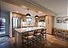 Beautifully designed kitchen and living area with breakfast bar seating for 3 people and dining seating for 4. 