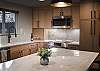 Beautifully designed kitchen and living area with breakfast bar seating for 3 people and dining seating for 4. 