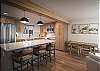 Beautifully designed kitchen and living area with breakfast bar seating for 3 people and dining seating for 4. 