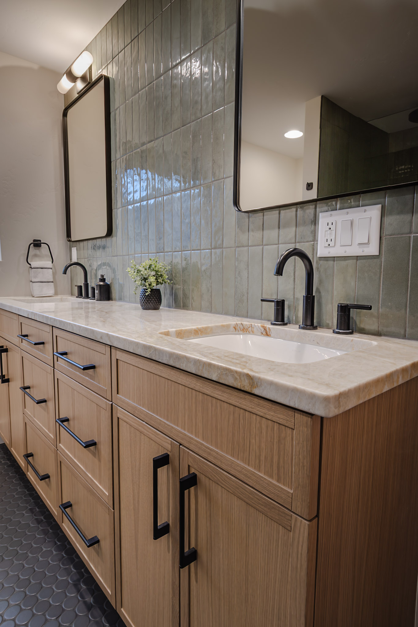 Full bathroom featuring two sinks and a sleek walk-in shower.