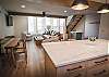 Beautifully designed kitchen and living area with breakfast bar seating for 3 people and dining seating for 4. 