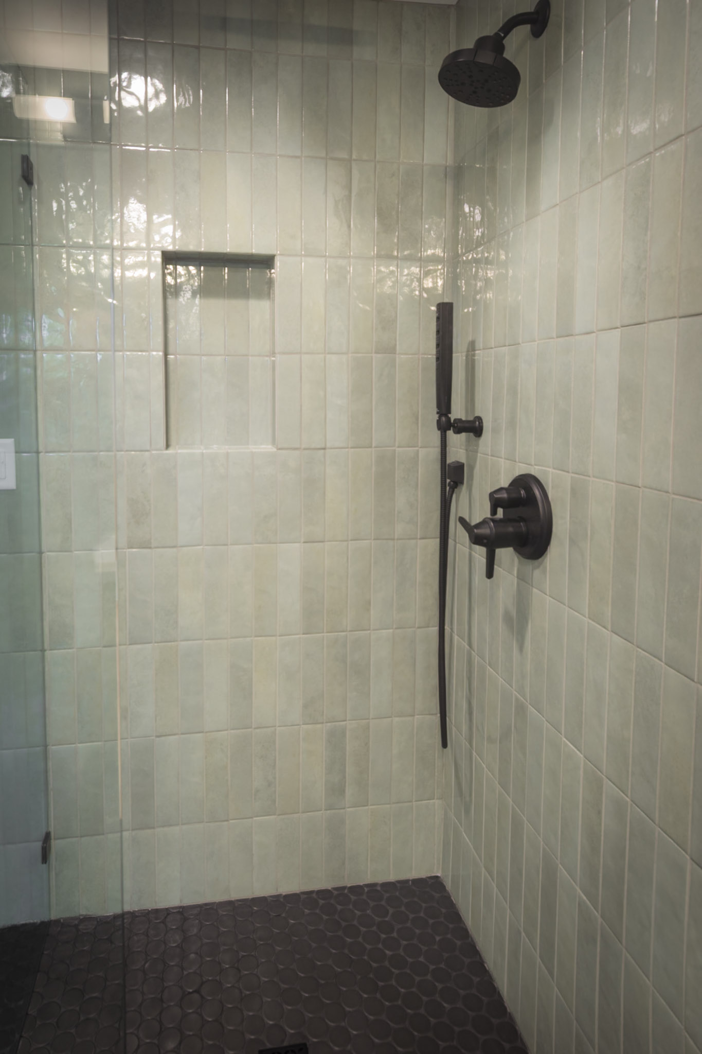 Full bathroom featuring two sinks and a sleek walk-in shower.