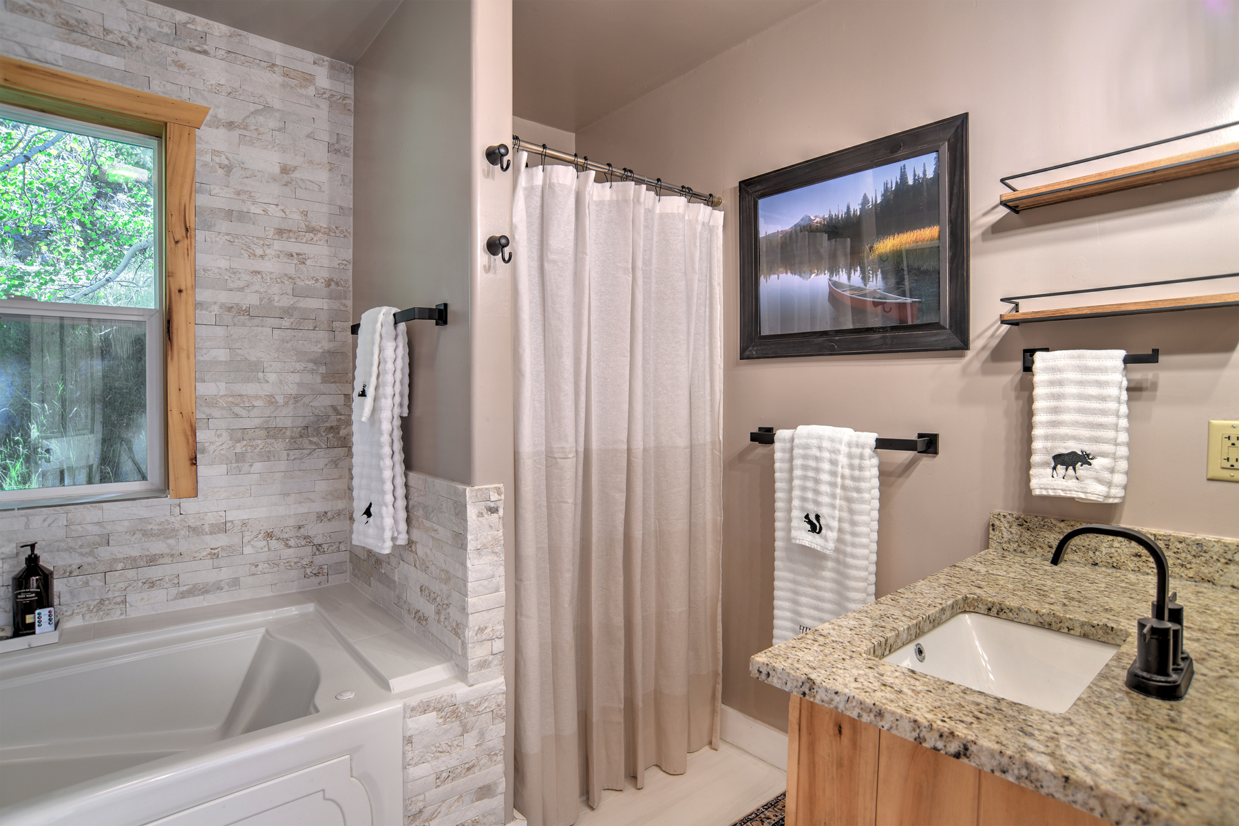 Full bathroom featuring a sleek walk-in shower and tub.