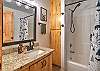 Full bathroom with convenient tub/shower combo and modern finishes.