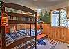 Kids bunk room with 5 beds and a galaxy projector.