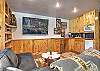 The downstairs area is complete with billiards, ping pong, a puzzle table, big screen TV, and popcorn machine for movie night. 