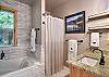 Full bathroom featuring a sleek walk-in shower and tub.