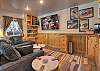 The downstairs area is complete with billiards, ping pong, a puzzle table, big screen TV, and popcorn machine for movie night. 