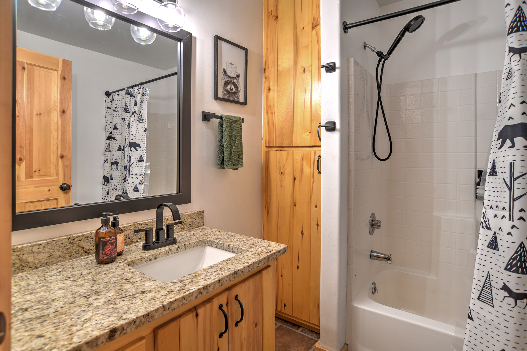 Full bathroom with convenient tub/shower combo and modern finishes.