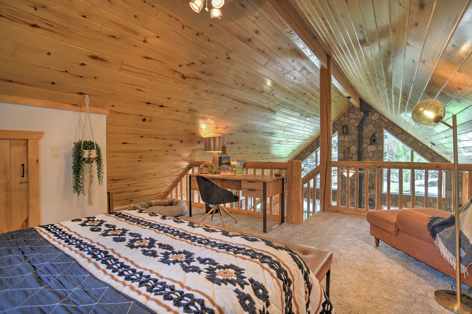 The loft queen bedroom offers a peaceful retreat, complete with a desk and chair.