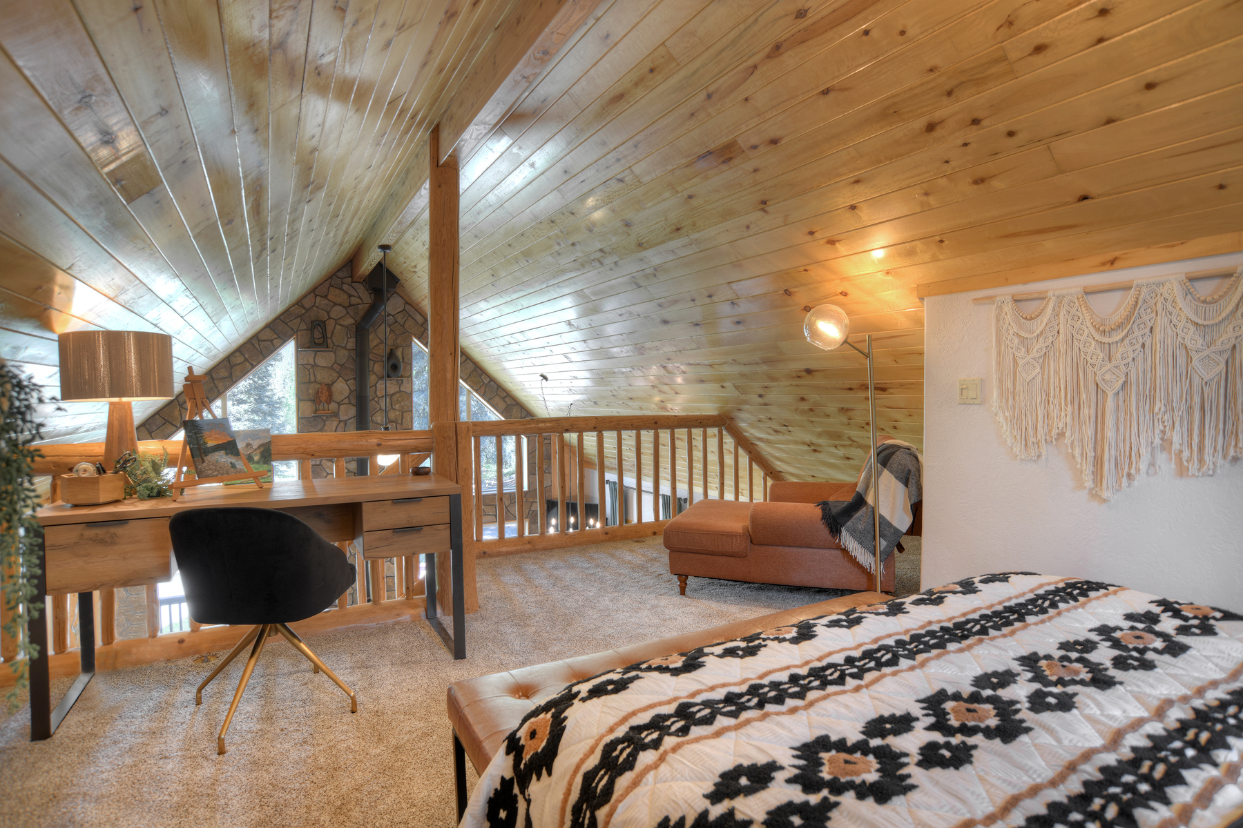 The loft queen bedroom offers a peaceful retreat, complete with a desk and chair.