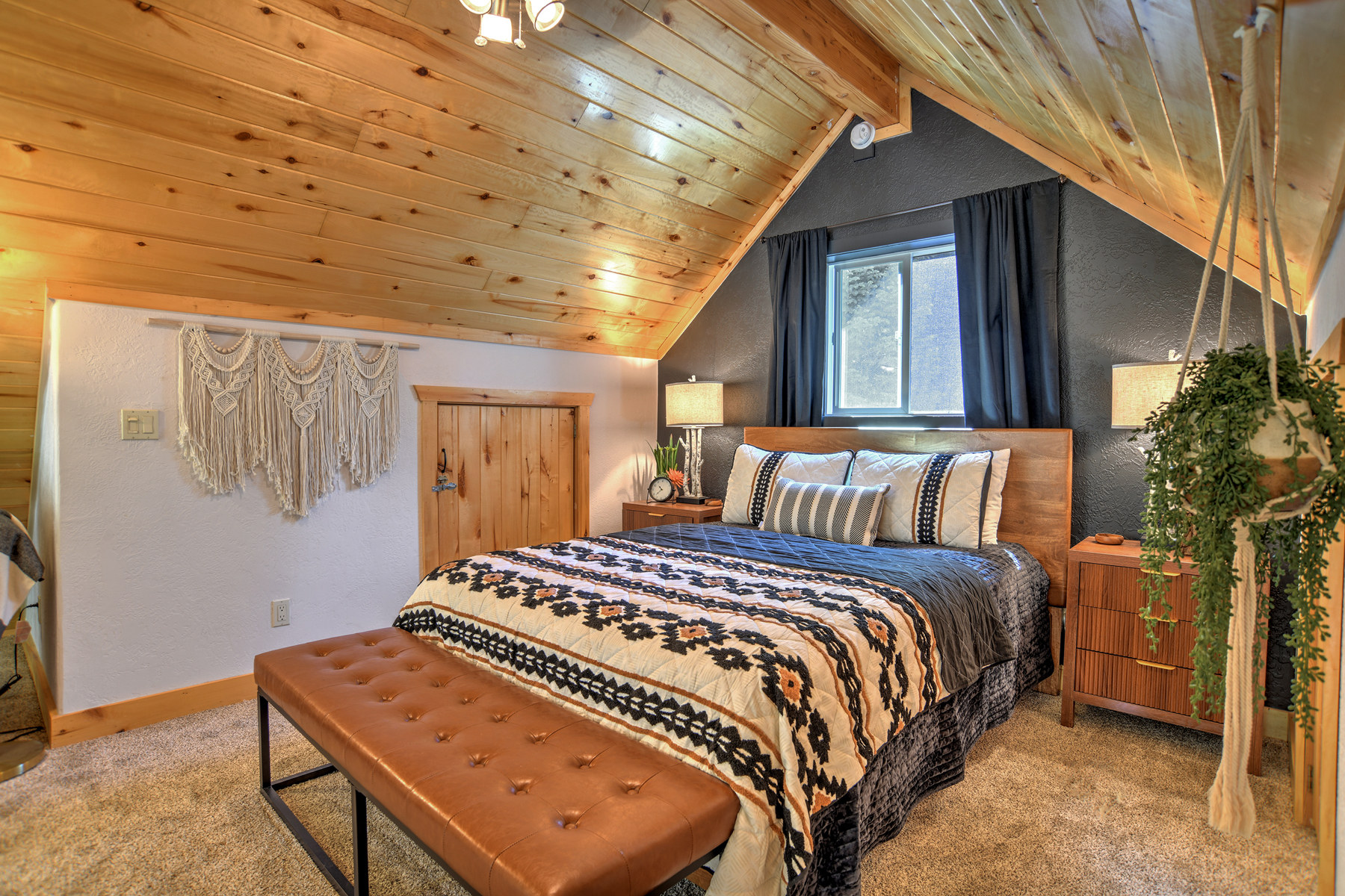 The loft queen bedroom offers a peaceful retreat, complete with a desk and chair.