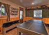 The downstairs area is complete with billiards, ping pong, a puzzle table, big screen TV, and popcorn machine for movie night. 