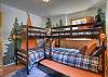 Kids bunk room with 5 beds and a galaxy projector.