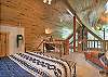The loft queen bedroom offers a peaceful retreat, complete with a desk and chair.