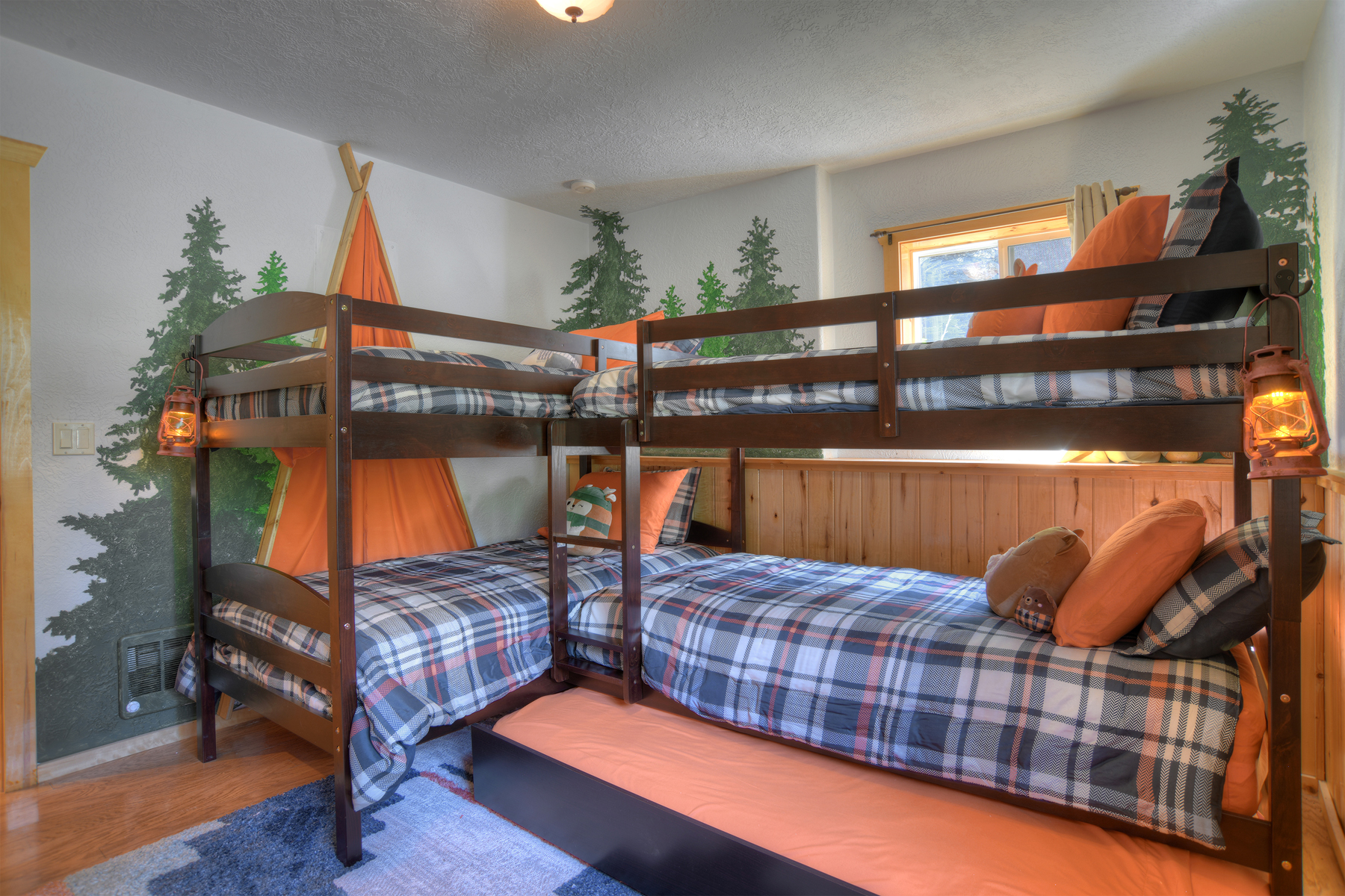 Kids bunk room with 5 beds and a galaxy projector.