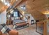 The loft queen bedroom offers a peaceful retreat, complete with a desk and chair.