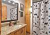 Full bathroom with convenient tub/shower combo and modern finishes.