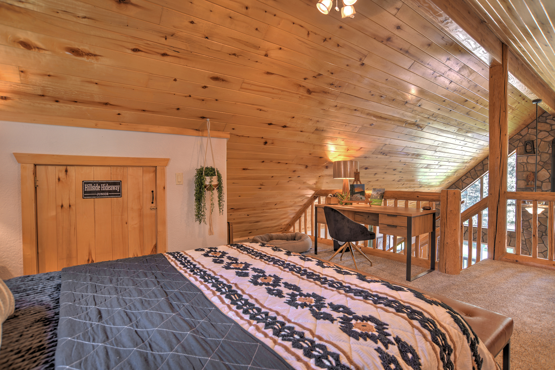 The loft queen bedroom offers a peaceful retreat, complete with a desk and chair.