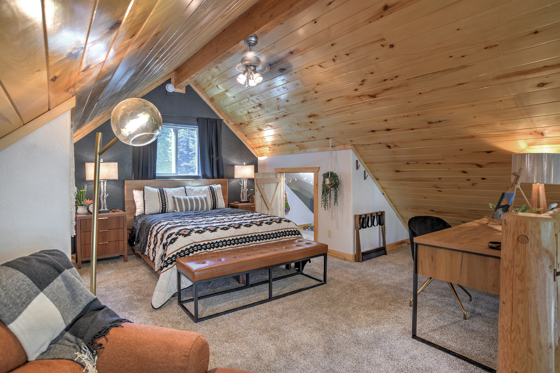 The loft queen bedroom offers a peaceful retreat, complete with a desk and chair.