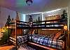 Kids bunk room with 5 beds and a galaxy projector.