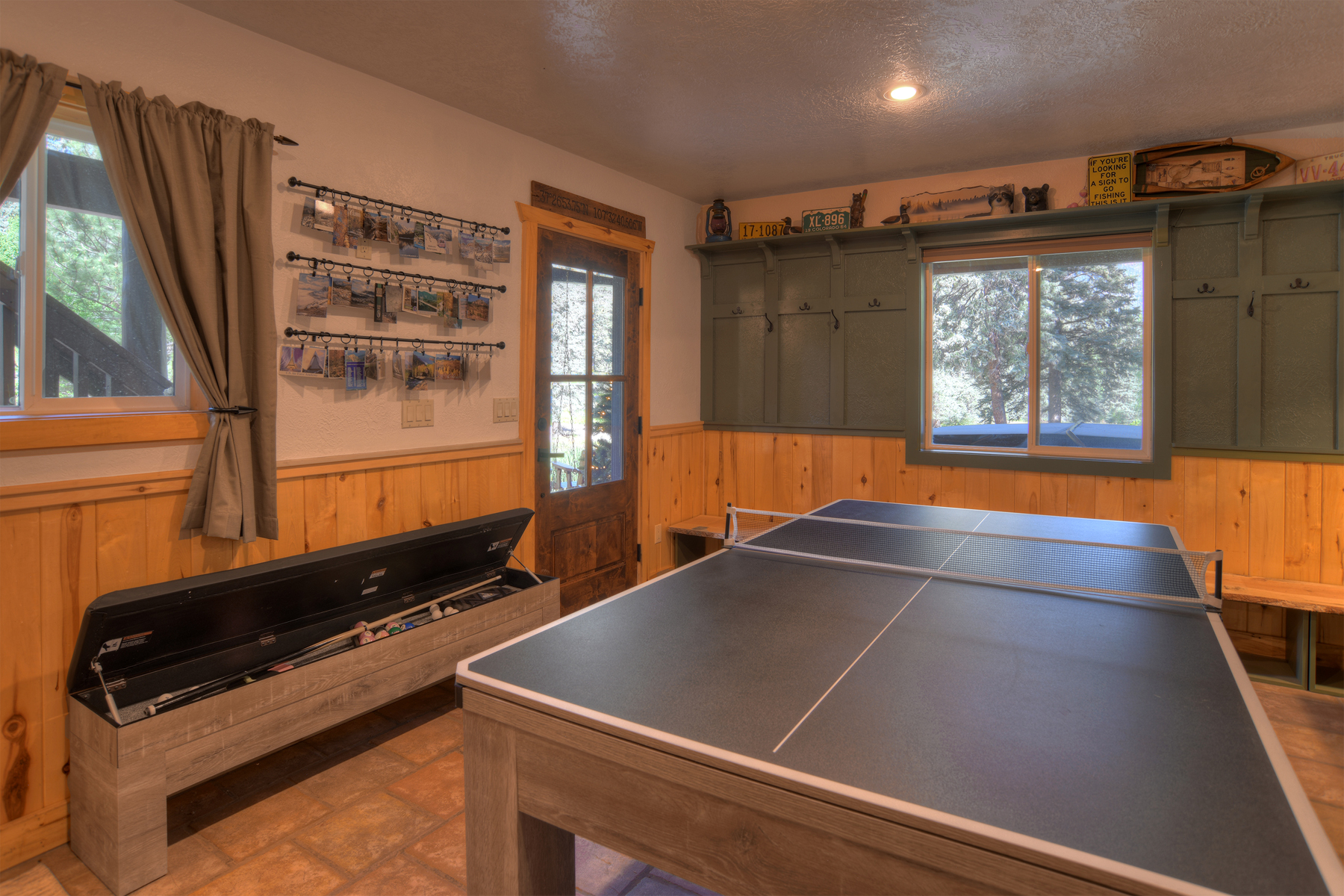 The downstairs area is complete with billiards, ping pong, a puzzle table, big screen TV, and popcorn machine for movie night. 