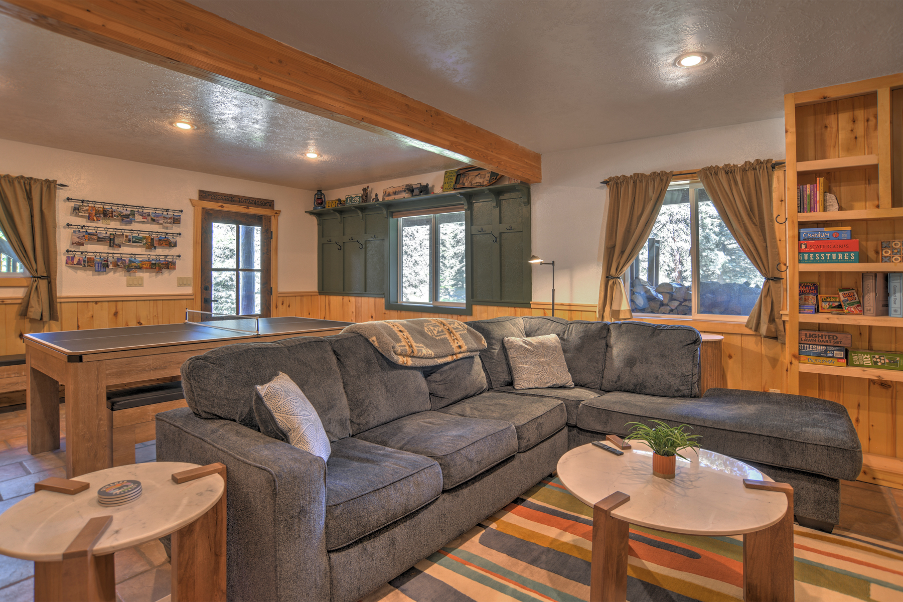The downstairs area is complete with billiards, ping pong, a puzzle table, big screen TV, and popcorn machine for movie night. 