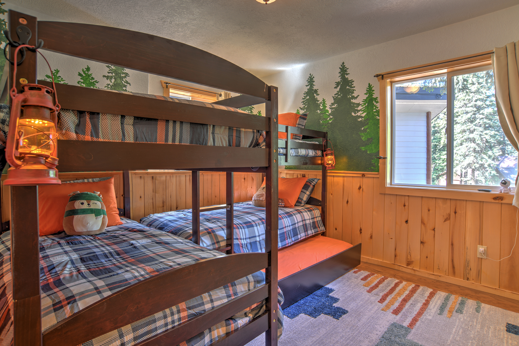 Kids bunk room with 5 beds and a galaxy projector.