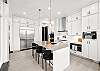 Whip up your favorite meals in this beautifully designed kitchen – includes breakfast bar seating for 3 and a Miele espresso maker.