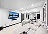 Curl up and enjoy a movie with family and friends in  the private home theatre with 75