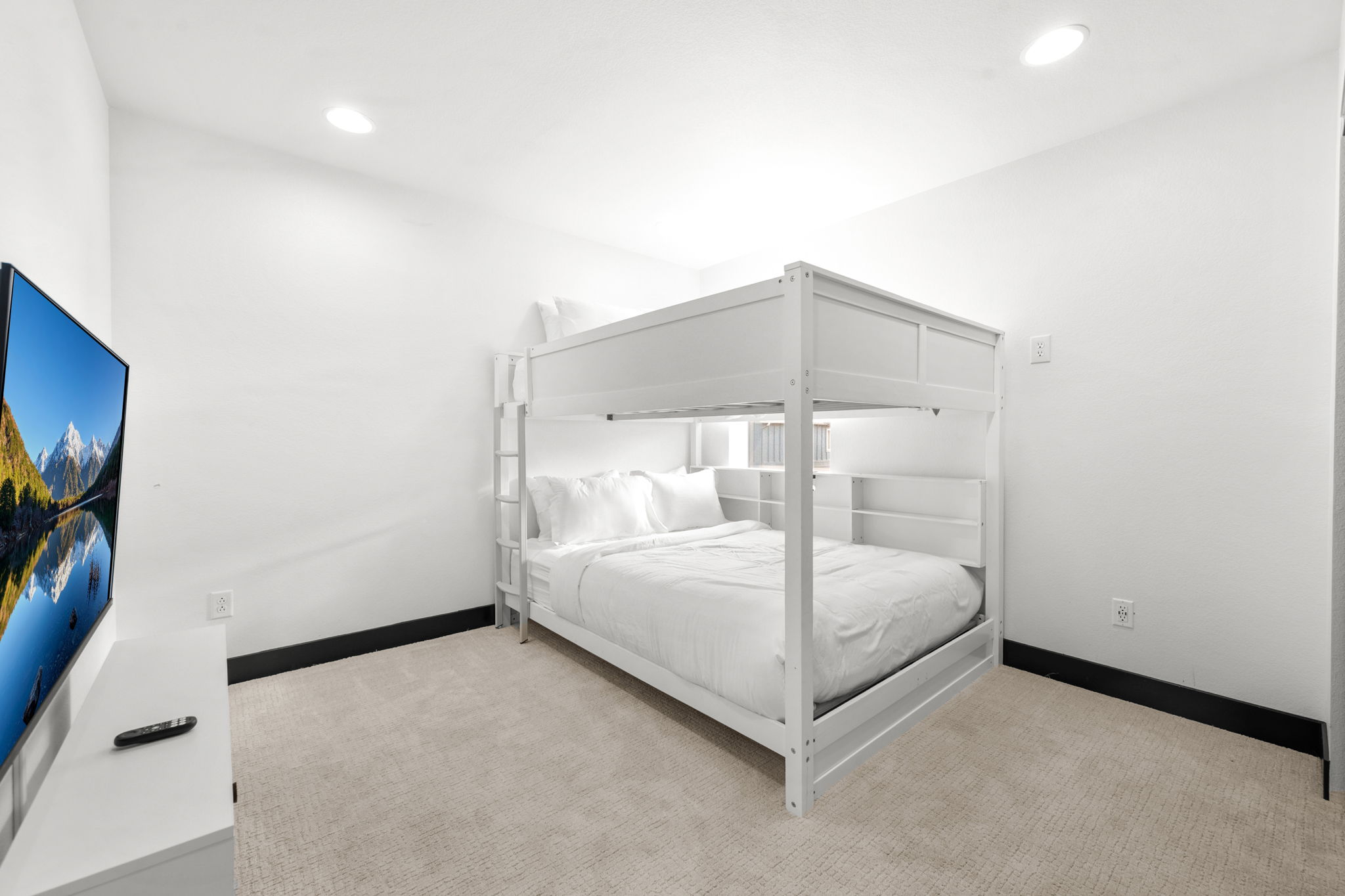 With plenty of space, this queen bunk bed room is perfect for the kids or couples. 