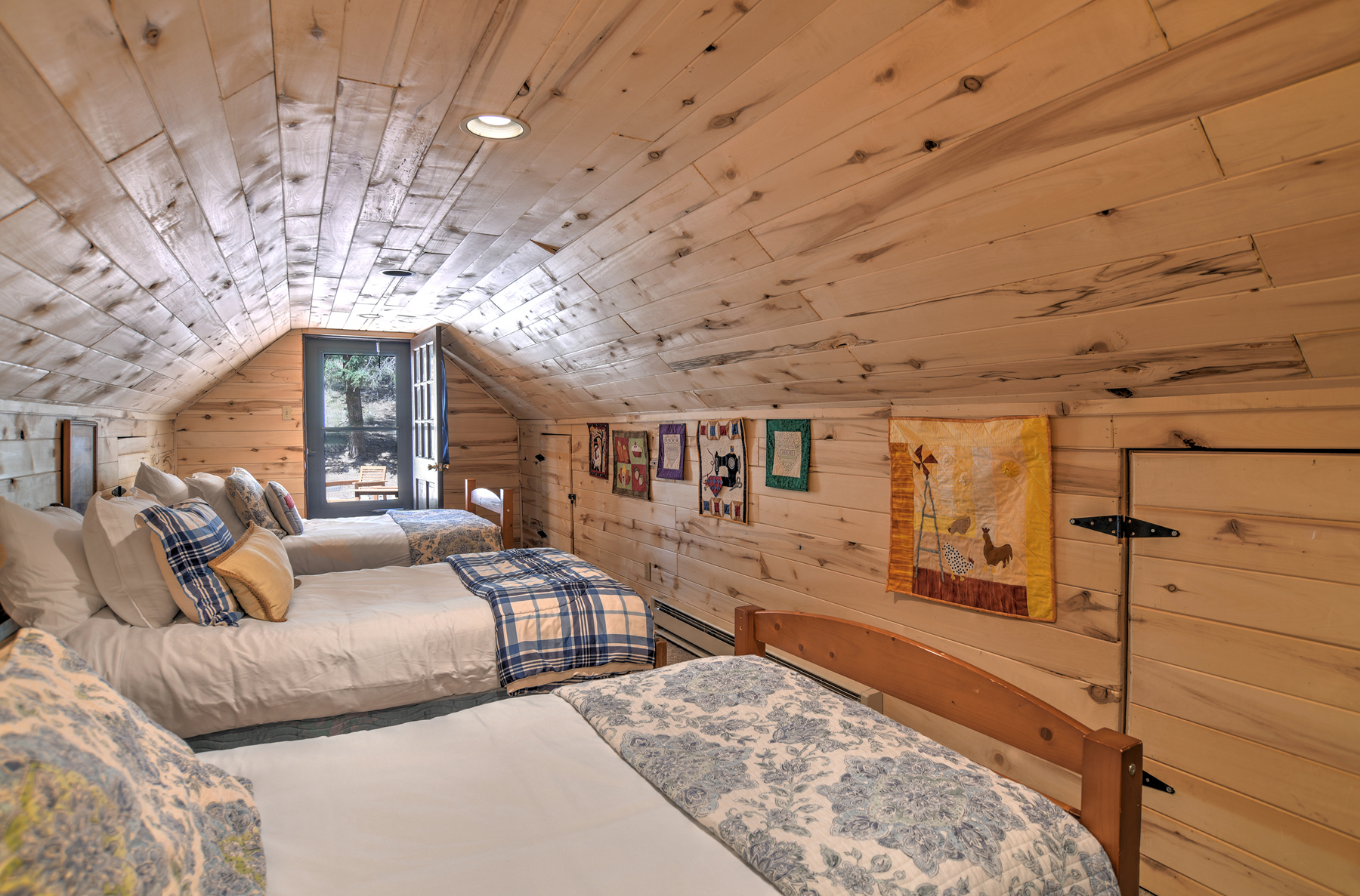 Fourth bedroom with three twin beds, accessible only through the king bedroom on the second story. To access the upstairs deck, you will have to go through both bedrooms.