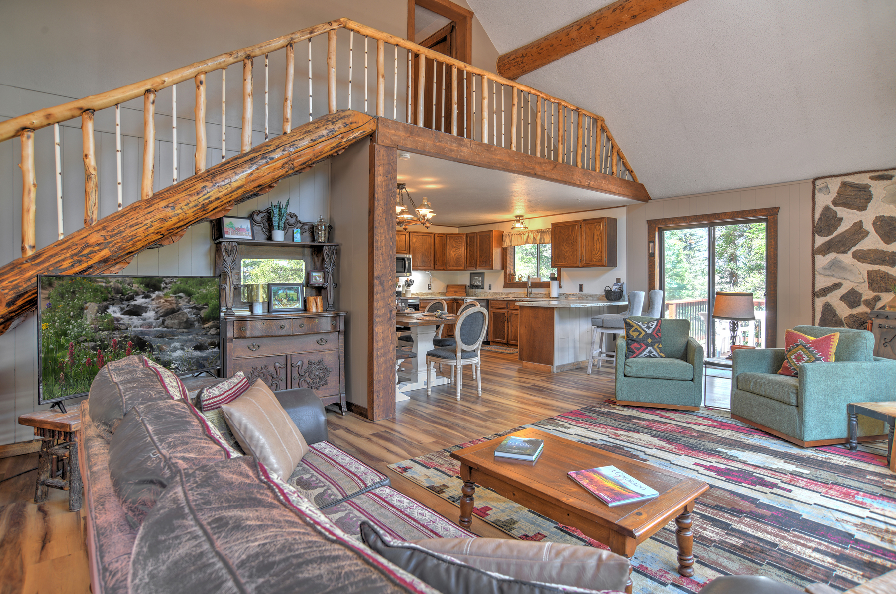 Living room with lots of windows perfect for enjoying the mountain and river views. 