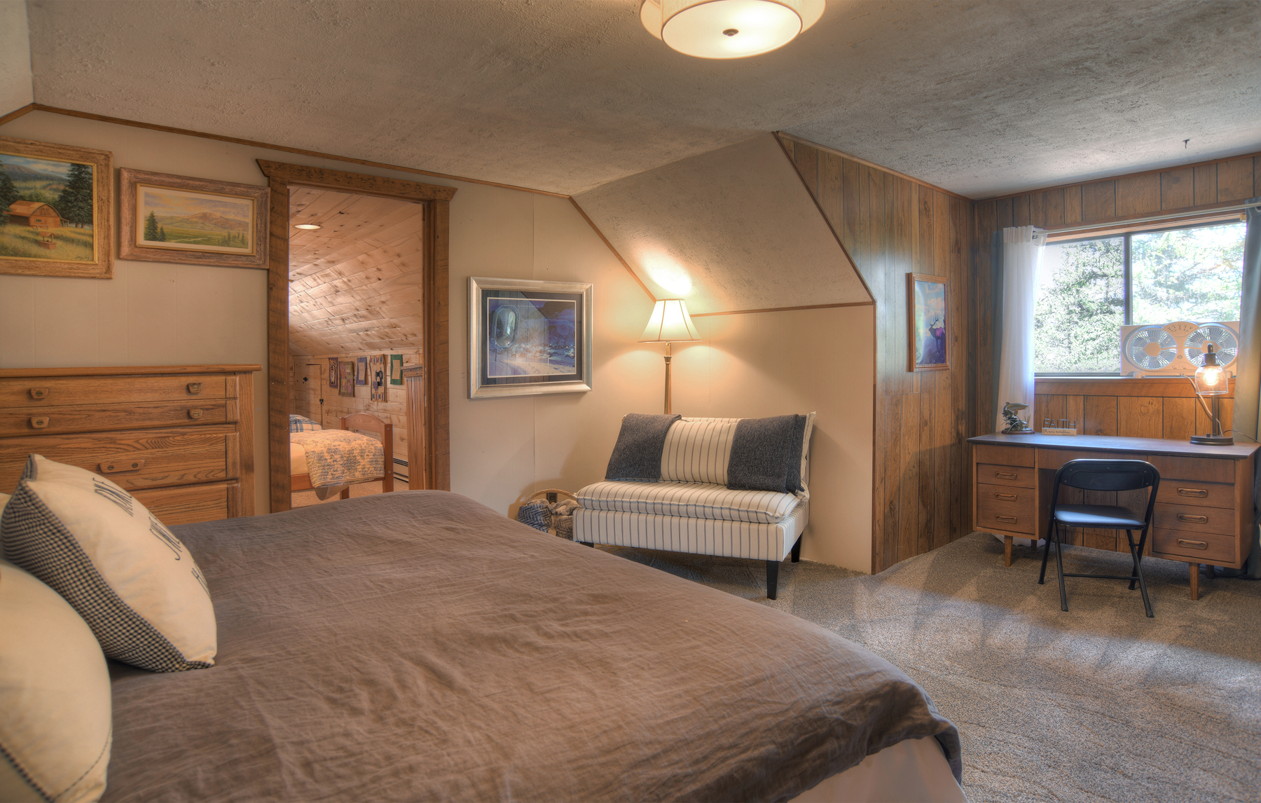 Second-story king bedroom with a remote workstation. Please note that the 4th bedroom is accessed from this bedroom and also the upper-level deck.